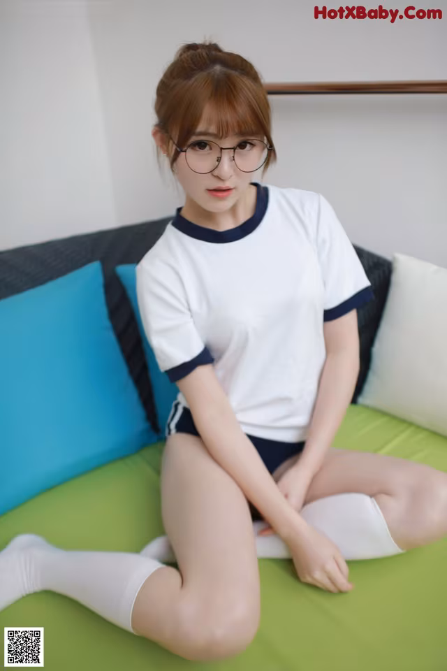 a woman sitting on top of a green couch