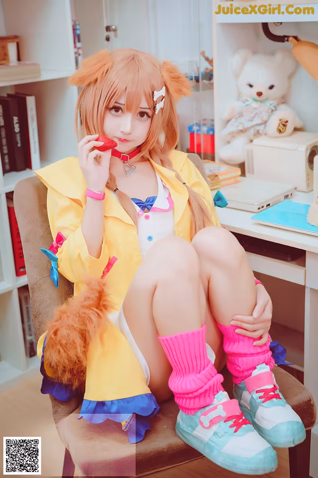 A woman sitting on a chair holding a teddy bear.
