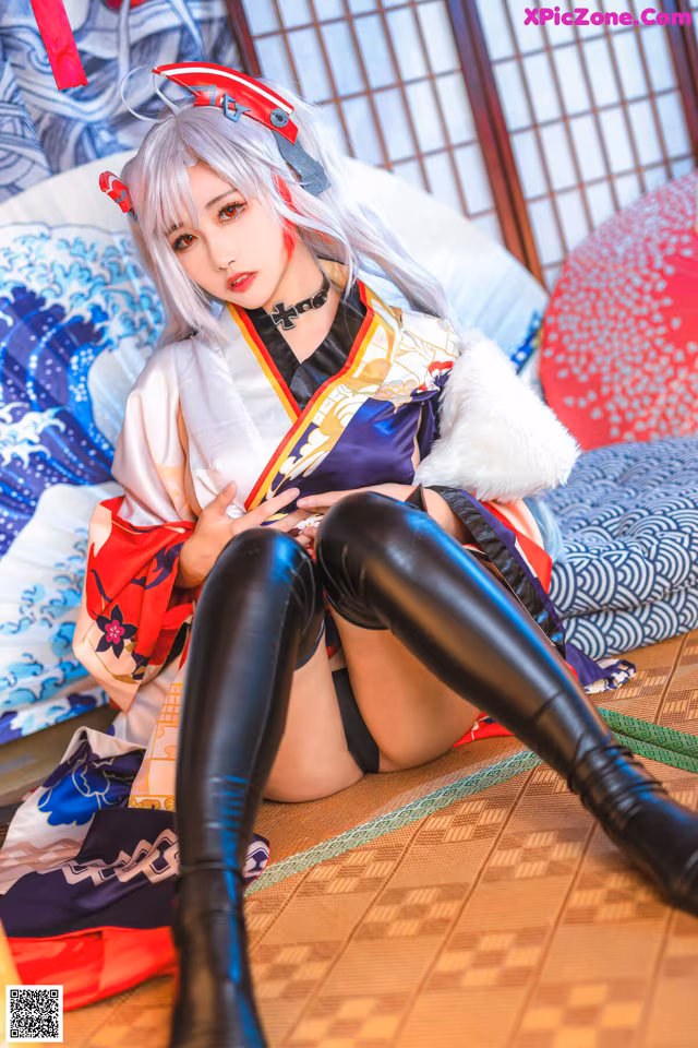 A woman in a kimono sitting on the floor.