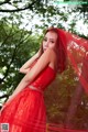 A woman in a red dress posing for a picture.