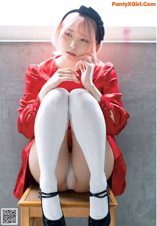 A woman sitting on top of a wooden chair wearing white stockings.