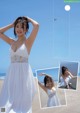 A woman in a white dress on the beach.