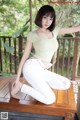 A woman sitting on top of a wooden table.